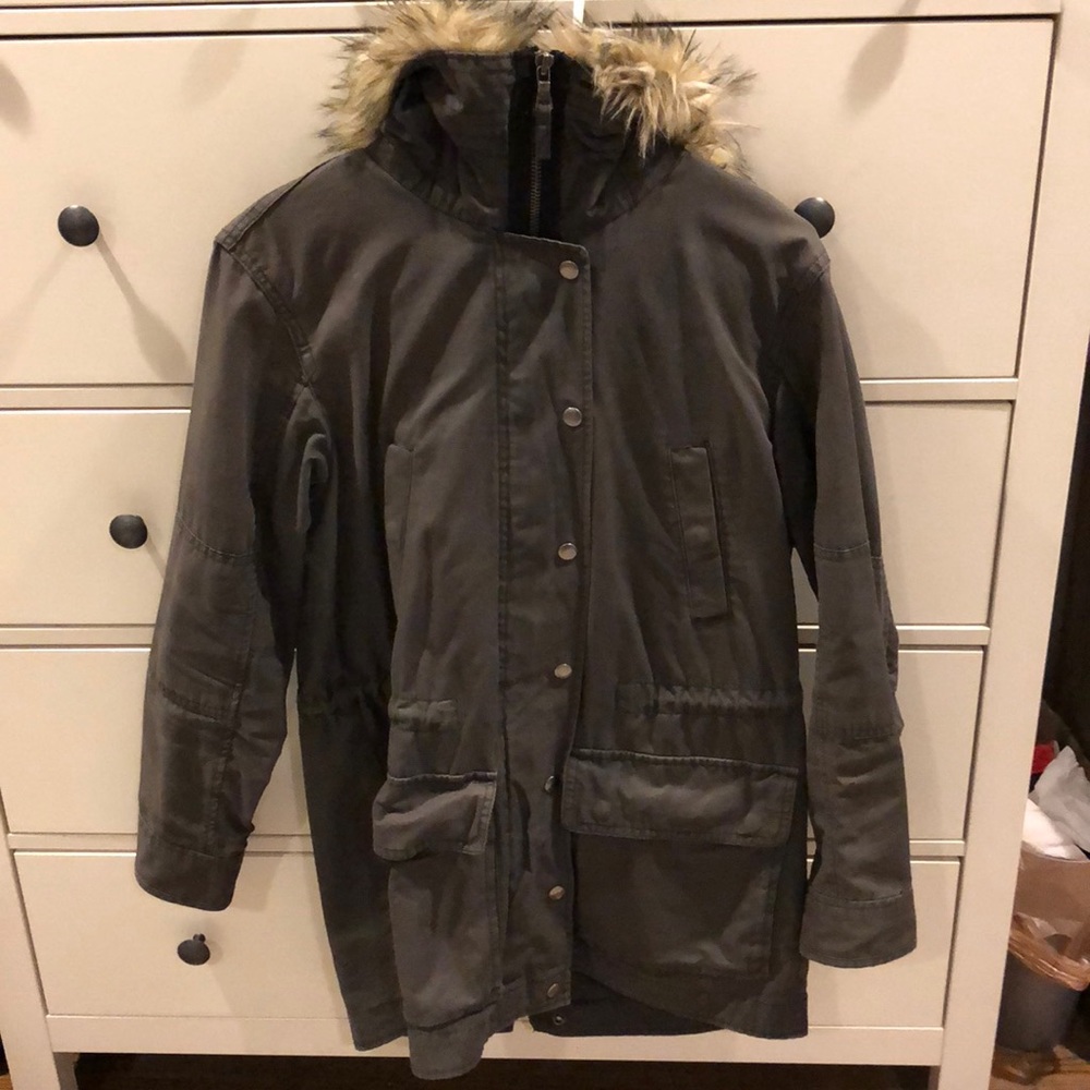Dark grey parka with fur hood.